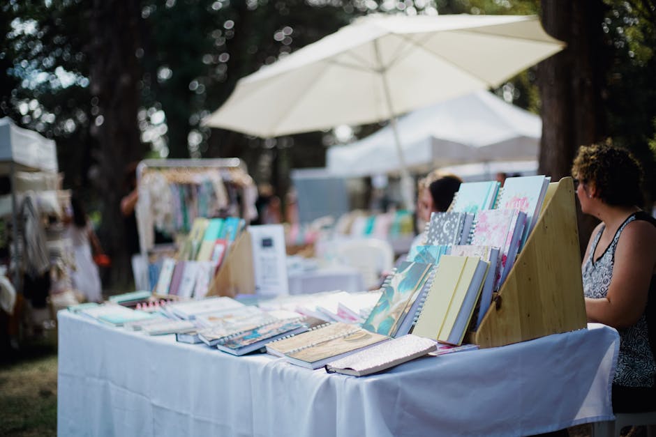 Outdoor market stall with colorful goods and people shopping on a sunny day